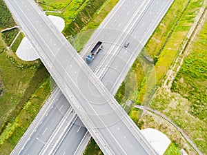 Aerial view of highway in city. Cars crossing interchange overpass. Highway interchange with traffic. Aerial bird`s eye photo of