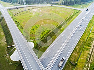 Aerial view of highway in city. Cars crossing interchange overpass. Highway interchange with traffic. Aerial bird`s eye photo of