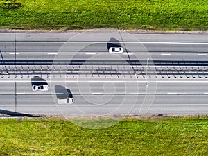 Aerial view of highway in city. Cars crossing interchange overpass. Highway interchange with traffic. Aerial bird`s eye photo of