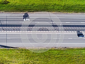 Aerial view of highway in city. Cars crossing interchange overpass. Highway interchange with traffic. Aerial bird`s eye photo of