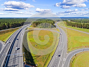 Aerial view of highway in city. Cars crossing interchange overpass. Highway interchange with traffic. Aerial bird`s eye photo of h