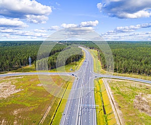 Aerial view of highway in city. Cars crossing interchange overpass. Highway interchange with traffic. Aerial bird`s eye photo of h