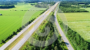 Aerial view of the highway among green fields