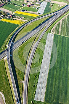 Aerial view of highway and green harvest fields