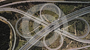 an aerial view of a highway intersection surrounded by trees