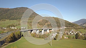 Aerial view of highway interstate road on a bridge with fast moving traffic in rural environment.