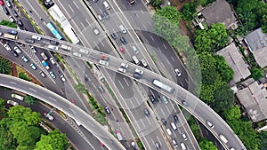 Aerial view of highway multi level junction road with moving cars. View of traffic jam passing through city center