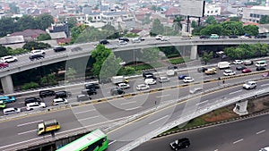 Aerial view of highway multi level junction road with moving cars. View of traffic jam passing through city center