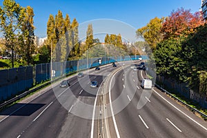 Aerial view of highway with multiple lanes and cars. Cars on highway road in busy city, urban view