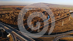 Aerial view. Highway and overpass with cars and trucks. The road junction is a two-tier road junction outside the city