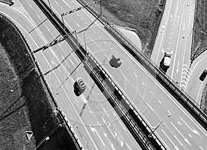 Aerial view of highway and overpass in city. Aerial view of cars crossing interchange overpass. Highway interchange with traffic.