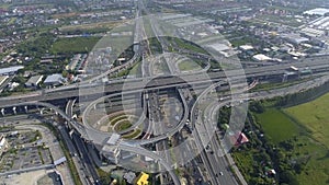 Aerial View of Highway Road Interchange with Busy Urban Traffic Speeding on Road