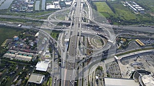 Aerial View of Highway Road Interchange with Busy Urban Traffic Speeding on Road