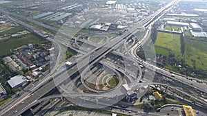 Aerial View of Highway Road Interchange with Busy Urban Traffic Speeding on Road