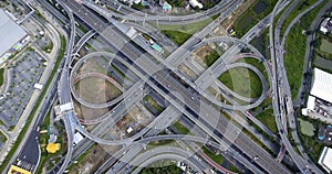 Aerial View of Highway Road Interchange with Busy Urban Traffic Speeding on Road