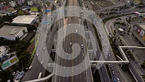 Aerial View of Highway Road Interchange with Busy Urban Traffic Speeding on Road