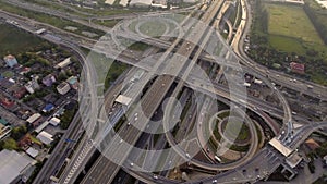 Aerial View of Highway Road Interchange with Busy Urban Traffic Speeding on Road