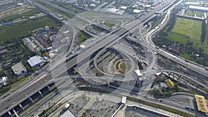 Aerial View of Highway Road Interchange with Busy Urban Traffic Speeding on Road