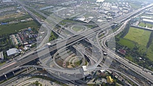 Aerial View of Highway Road Interchange with Busy Urban Traffic Speeding on Road