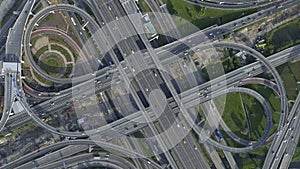 Aerial View of Highway Road Interchange with Busy Urban Traffic Speeding on Road