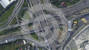 Aerial View of Highway Road Interchange with Busy Urban Traffic Speeding on Road