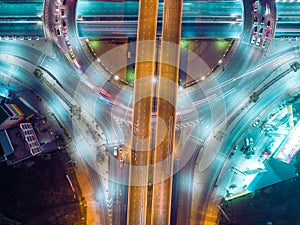 Aerial view highway road intersection at night for transportation, distribution or traffic background