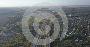 Aerial view of highway. Road junctions in green field. Interchange highway road 4k 4096 x 2160