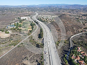 Aerial view of highway with traffic surrounded by houses, Interstate 15 with in vehicle movement.