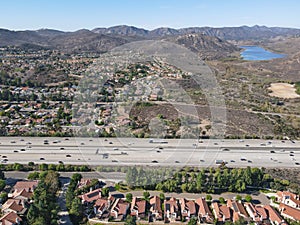 Aerial view of highway with traffic surrounded by houses, Interstate 15 with in vehicle movement.