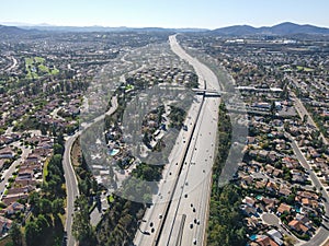 Aerial view of highway with traffic surrounded by houses, Interstate 15 with in vehicle movement.