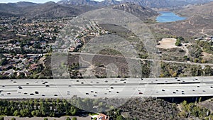 Aerial view of highway with traffic surrounded by houses, Interstate 15 with in vehicle movement.