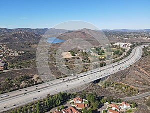 Aerial view of highway with traffic surrounded by houses, Interstate 15 with in vehicle movement.