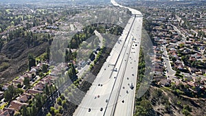 Aerial view of highway with traffic surrounded by houses, Interstate 15 with in vehicle movement.