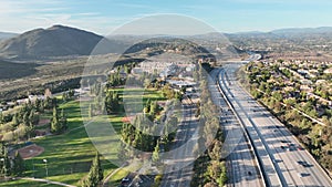 Aerial view of highway with traffic surrounded by houses, Interstate 15 with in vehicle movement.