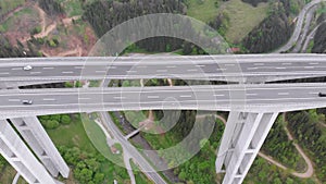 Aerial view of the Highway Viaduct on Concrete Pillars with Traffic in Mountains