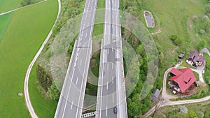 Aerial view of the highway viaduct on concrete pillars with traffic in mountains