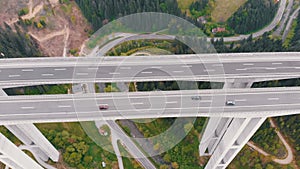 Aerial view of the Highway Viaduct on Concrete Pillars with Traffic in Mountains