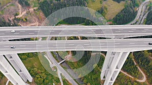 Aerial view of the Highway Viaduct on Concrete Pillars with Traffic in Mountains