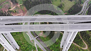 Aerial view of the Highway Viaduct on Concrete Pillars with Traffic in Mountains