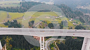 Aerial view of the Highway Viaduct on Concrete Pillars with Traffic in Mountains