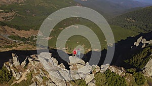 Aerial View of Hiker Couple of Tourists with Backpack on Top of a Mountain