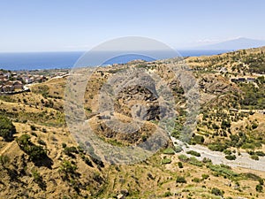 Aerial view of hills in the hinterland of Calabria. Etna volcano and sicily in the background