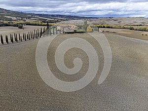 Aerial view on hills of Val d`Orcia, Tuscany, Italy. Tuscan landscape with ploughed fields in autumn