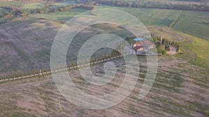 Aerial view of Hilly countryside of Tuscany in sunny morning in Val d`orcia, near Pienza, Italy, April. Cypress alley