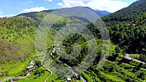 Aerial view of hilly landscape with rural terrace farming and village of Uttarakhand, India