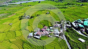 Aerial view of hilly landscape with rural terrace farming and village of Uttarakhand, India