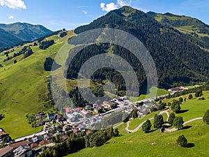 Aerial view of Hinterglemm village and mountains with skiing lifts in Saalbach-Hinterglemm skiing region in Austria on a