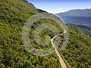 Aerial view of the hinterland of Montenegro, winding roads that cross lush hills
