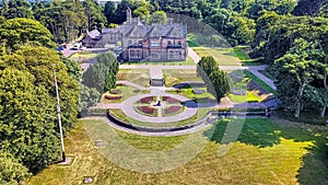 Aerial view of the historic Bangor Castle surrounded by lush green landscape in Northern Ireland.