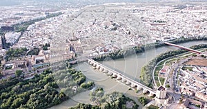 Aerial view of Historic centre of Cordoba with antique Roman Bridge over Guadalquivir river and medieval Mosque